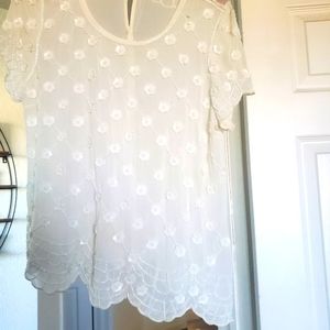 White sheer top with beaded flowers.